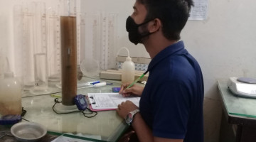 Reading of hydrometer test is being taken